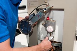 Tim is repairing a conventional water heater